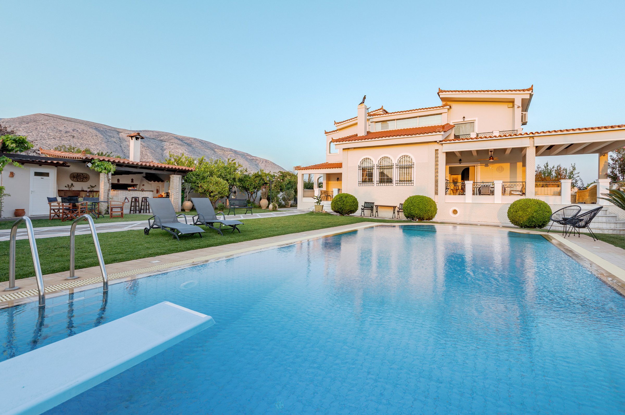 Renko Royal Villa private infinity pool in daylight, Athens Riviera, Greece