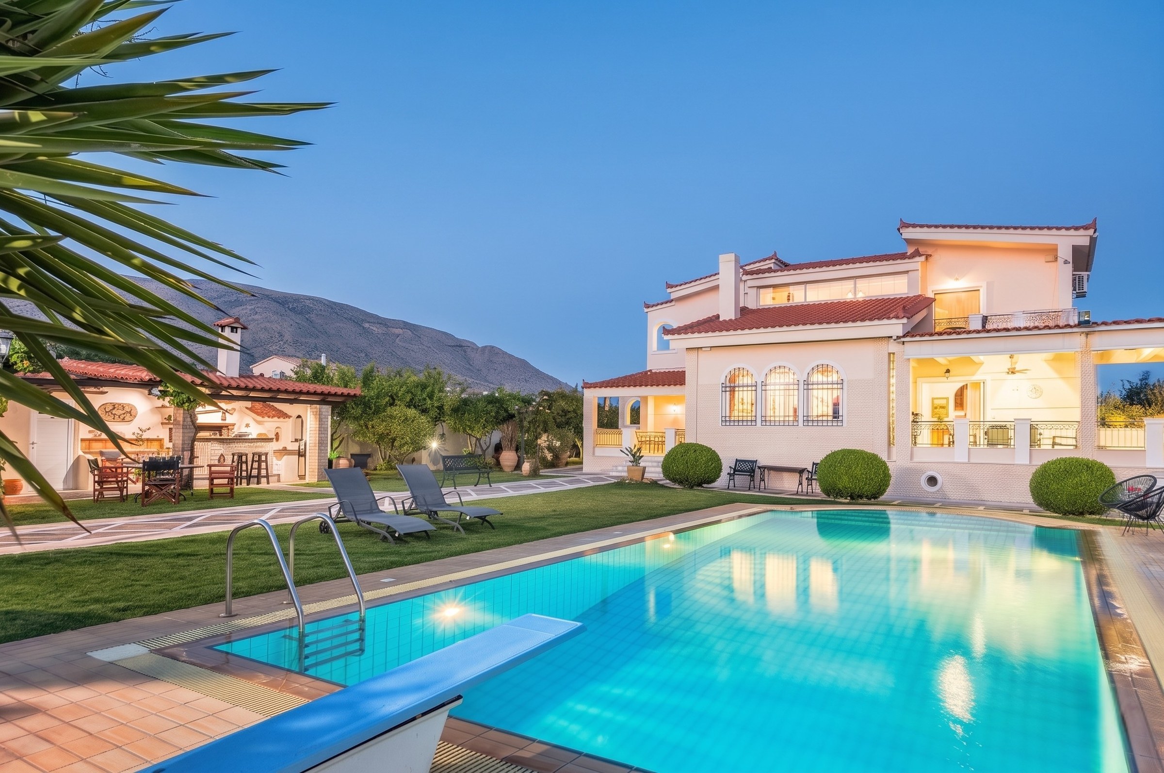 Renko Royal Villa at blue hour with infinity pool, Athens Riviera, Greece