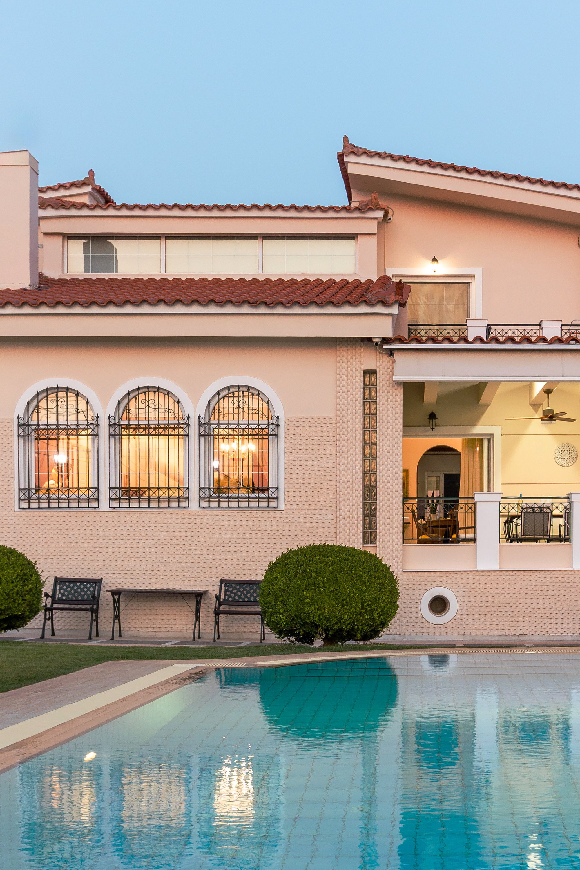 Renko Royal Villa exterior at blue hour with pool reflection, Athens Riviera